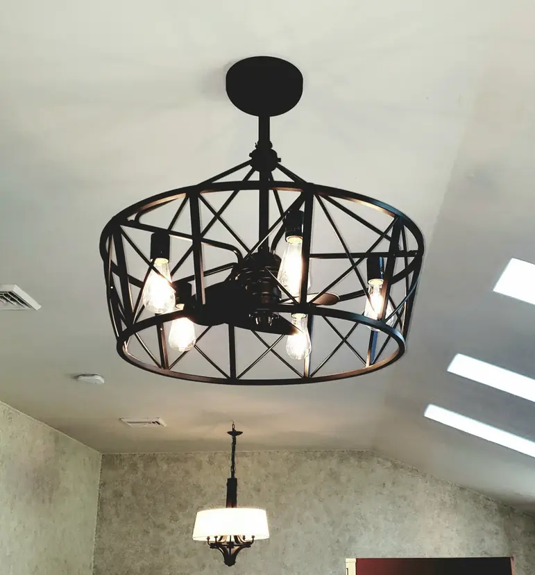 Industrial cage ceiling fixture installed on a vaulted ceiling